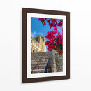 Histórico Monasterio de Yuriria enmarcado por vibrantes bugambilias bajo un cielo azul despejado. - Nosion | Cuadro decorativo de Canvas Lab